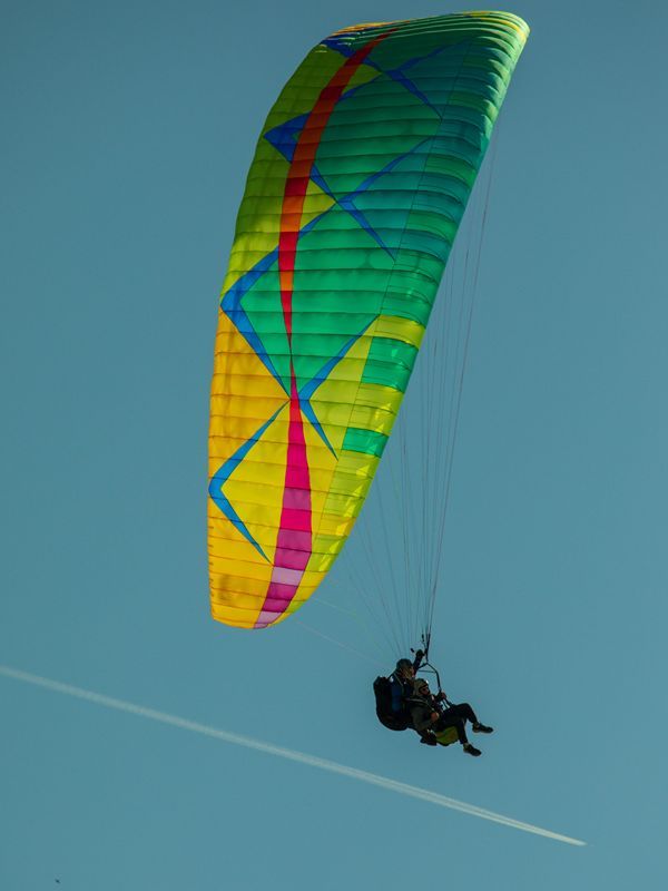 Close-up of a colorful tandem paraglider wing during a flight in Budva, Montenegro.
