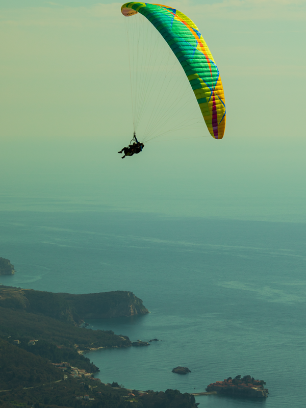 Tandem paragliding flight over Budva and Sveti Stefan island in Montenegro.